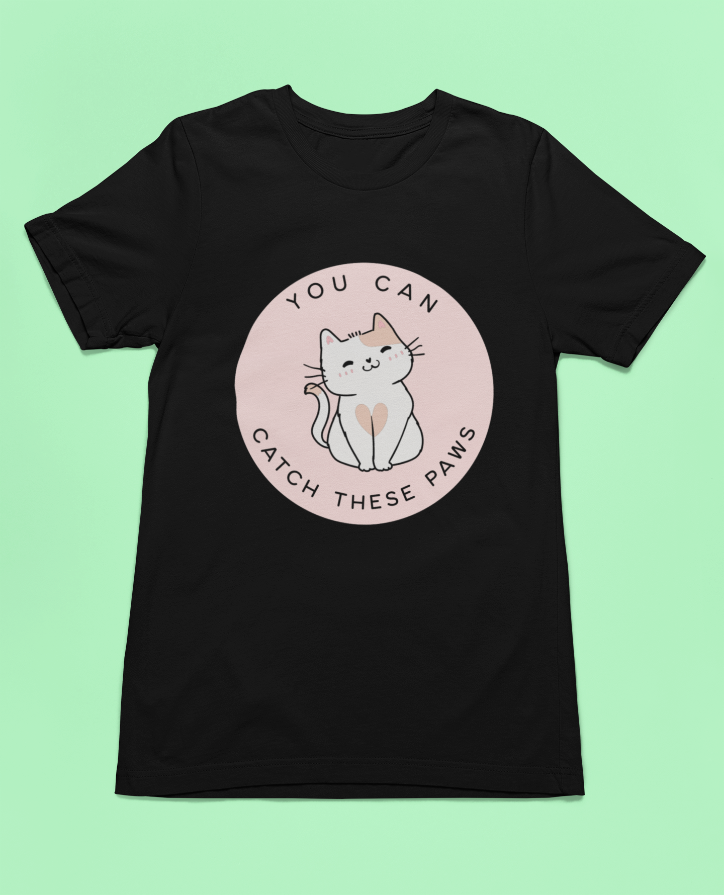 A black T-shirt with a graphic of a cat and the text 'YOU CAN CATCH THESE PAWS' on the front.