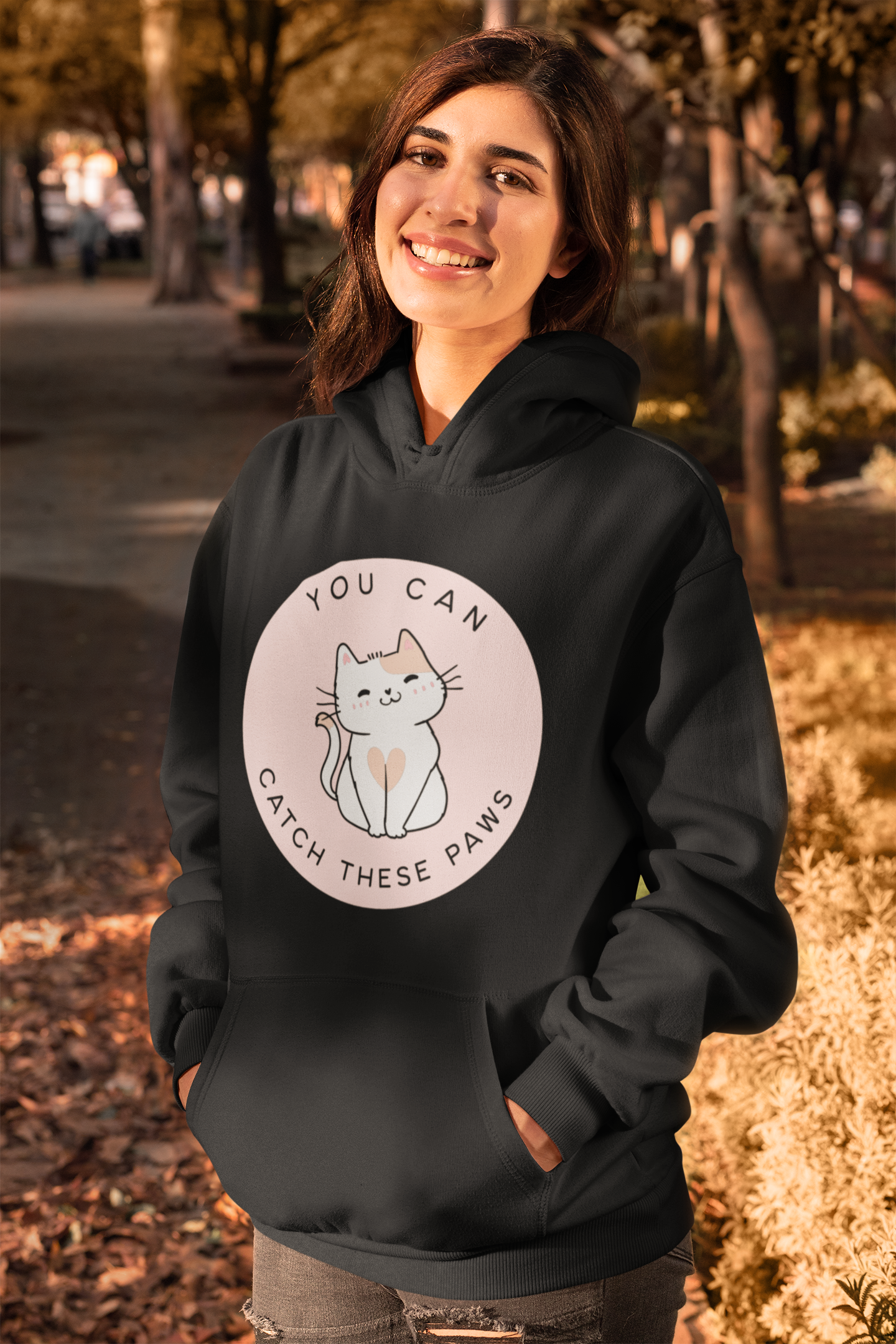 Cozy cat-themed hoodie featuring a playful smiling cat and the phrase “You Can Catch These Paws” — perfect gift for fun-loving cat owners | Kitty Crush